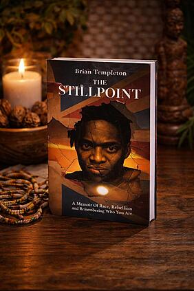 The Stillpoint book by Brian Templeton displayed with candlelight on wooden surface - memoir about race, rebellion and identity